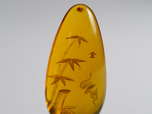 Yihen Natural Amber master carving 'Bat and Bamboo'. 44 x 20mm. 30.10 cts.