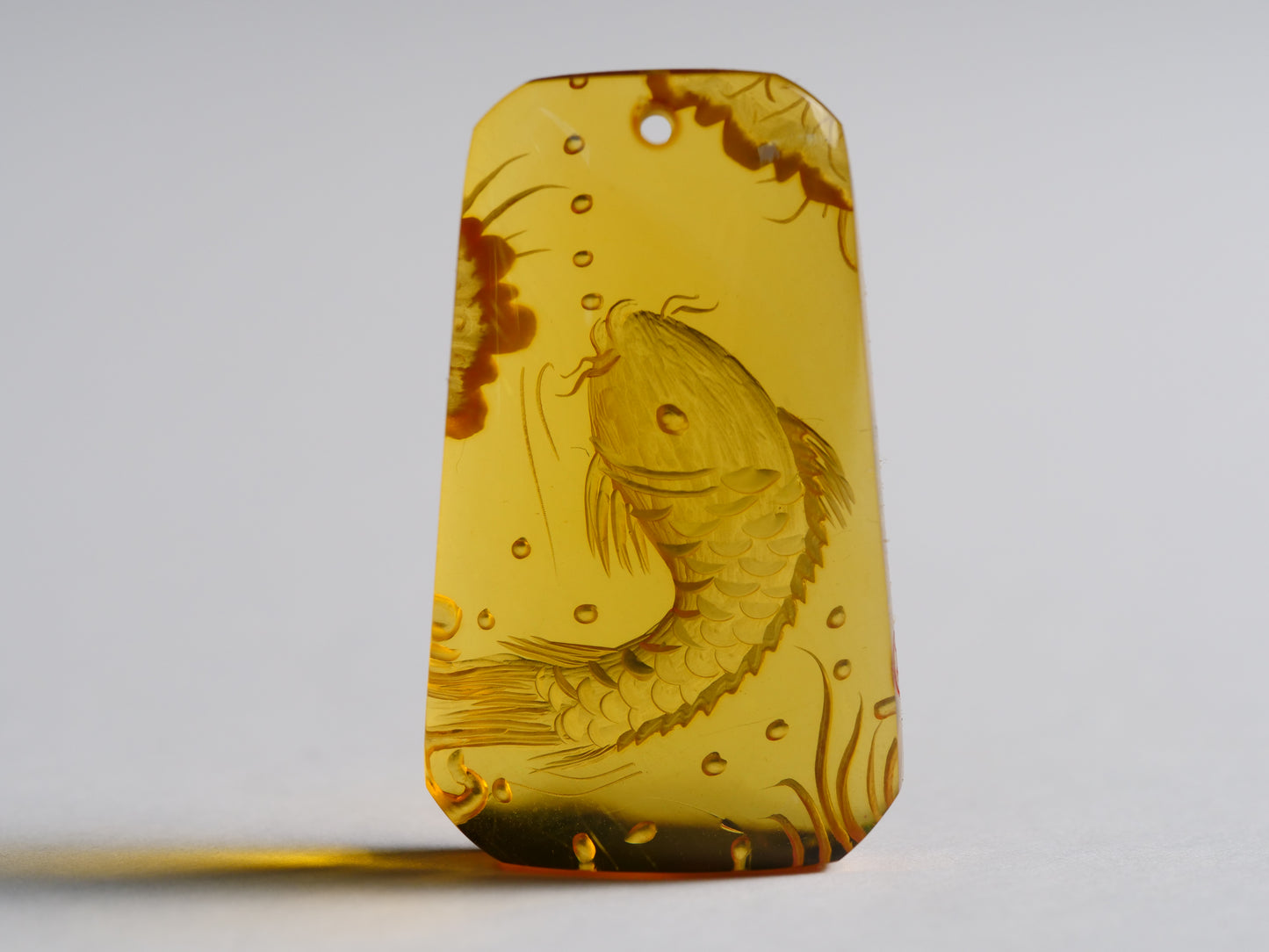 Yihen Natural Amber master carving 'Longmen Gate'. 35 x 20mm. 23.75 cts.