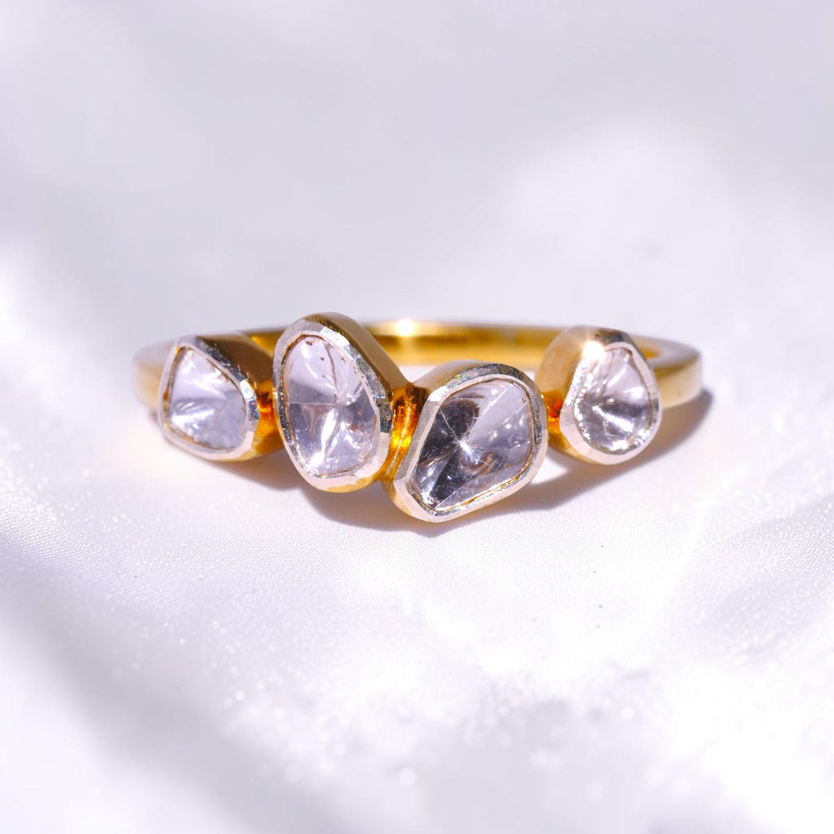 Gold ring set with four uncut polki diamonds