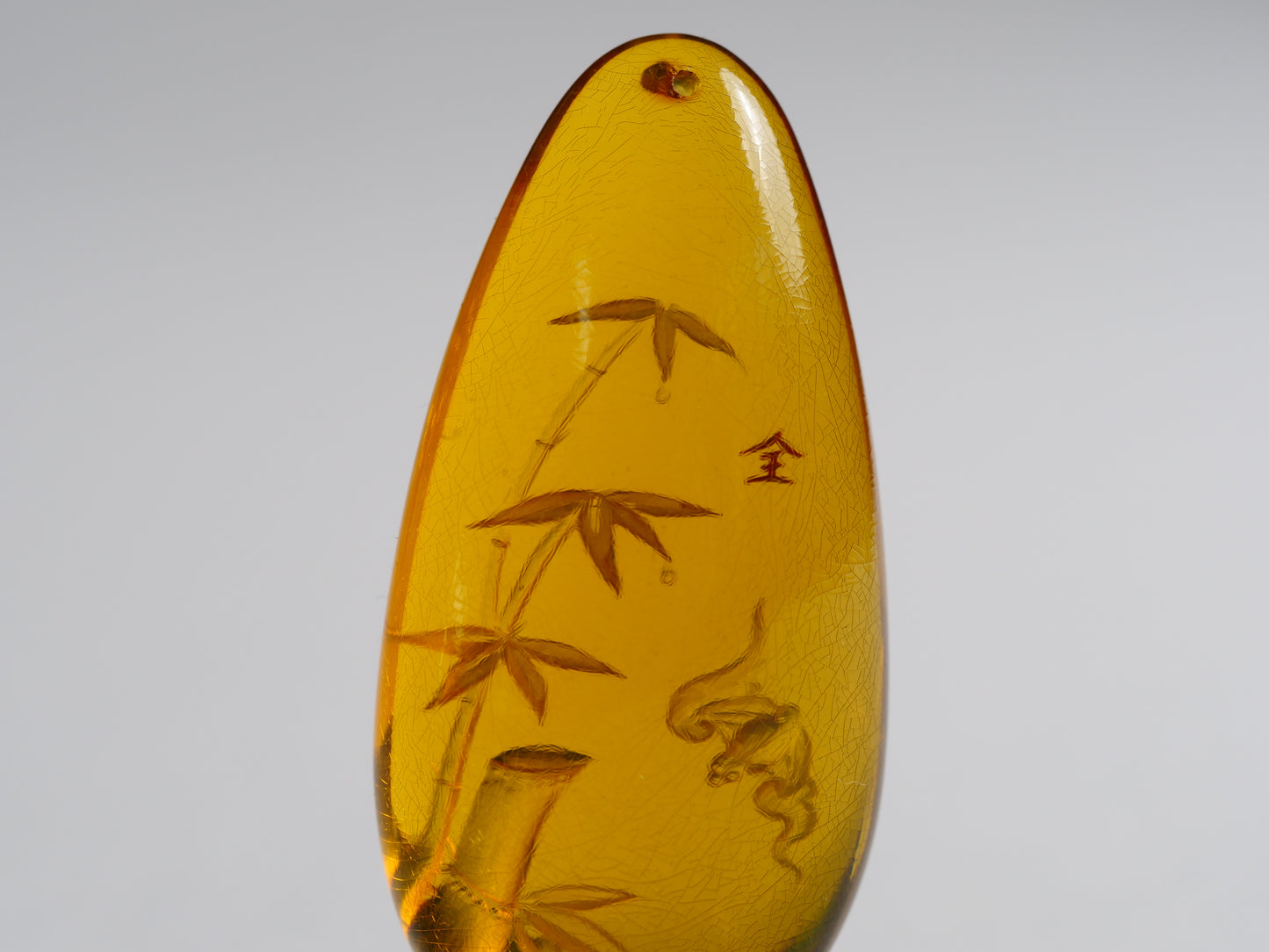 Yihen Natural Amber master carving 'Bat and Bamboo'. 44 x 20mm. 30.10 cts.